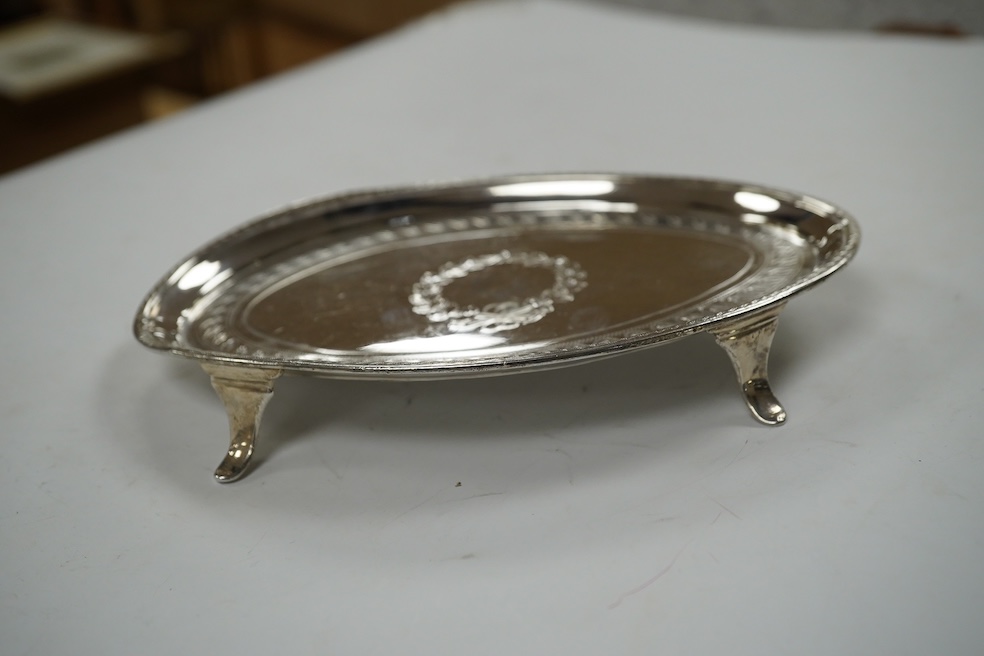 A George III engraved silver oval teapot stand, London, 1796, on four swept feet, 17.3cm, 137 grams. Condition - poor.